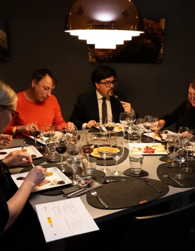 Guests tasting Spanish food and wine at a private dinner event in Tallinn