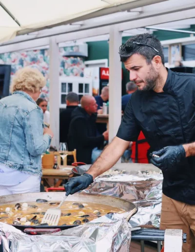 Chef cooking seafood paella outdoors at a private event in Pärnu