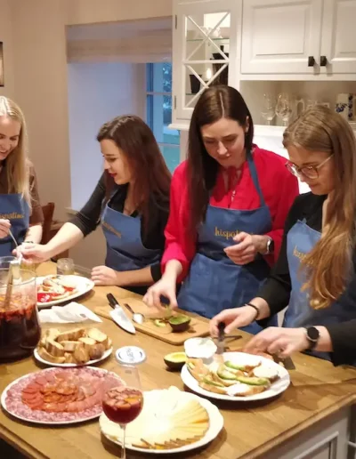 Guests preparing Spanish tapas during a private cooking masterclass in Tallinn