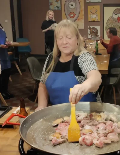 Guests tasting Spanish food and wine and cooking at a private dinner event in Tallinn