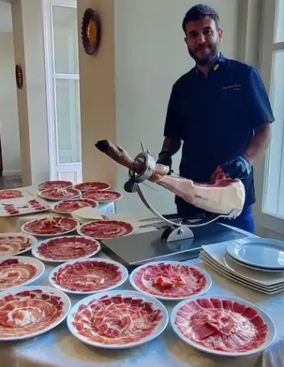 Spanish jamón carving station with plated in servings at a wedding in Riga